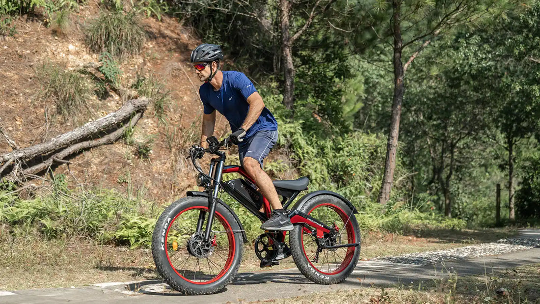 Duotts N26 all-terrain fat tire electric bike riding through snow and sandy paths with 26x4.0 inch tires.