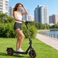 KingSong E1 KSE electric scooter with an adult beside an urban riverside path