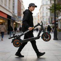 Adult carrying the folded KingSong E1 KSE electric scooter through a city